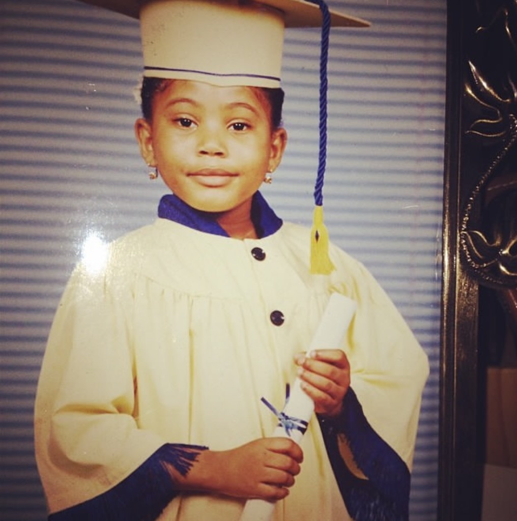 Dr. Loriane Clarke as a child at her graduation, holding a diploma